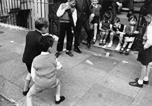 Two boys playing Knock em Down in a London street