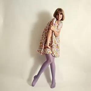 Female model in floral minidress and purple tights