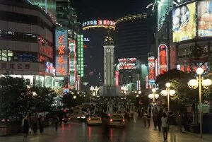 Tourist Attractions Collection: China, Chongqing, Jiefangbei or Victory Monument, floodlit clock-tower surrounded by a busy