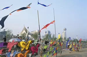 Tourist Attractions Collection: China, Hubei, Wuhan, Yangzi riverfront, colourful kites for sale blowing in the wind