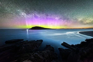 Colorful Gallery: Colourful display of the Aurora Australis over an island in the ocean at Blue Hour