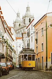 Church Collection: Famous yellow tram on the narrow streets of Alfama district, Lisbon, Portugal