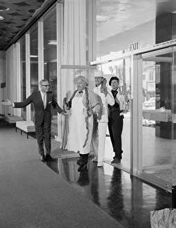Four People Gallery: Man welcoming chefs, smiling