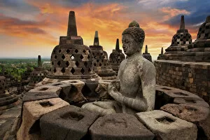 Sunrise with a Buddha Statue with the Hand Position of Dharmachakra Mudra in Borobudur, Magelang, Central Java