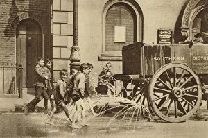 Enjoying Collection: Children in Poplar enjoying the passing of a water cart during a heatwave (b / w photo)
