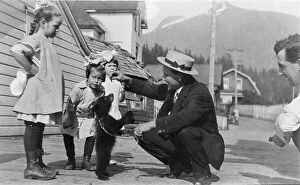 Enjoying Collection: White people with bear cub, between c1900 and c1930. Creator: Unknown