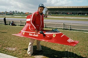 1974 Belgian Grand Prix - Niki Lauda: Niki Lauda playing with bodywork from his Ferrari 312B3. Portrait