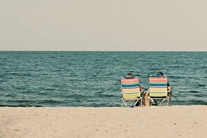 Enjoying Collection: Couple at the beach sitting on beach chairs